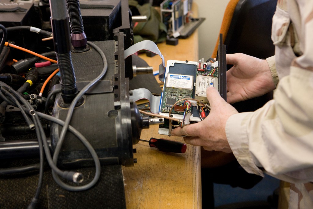 Technician Working on Foster-Miller Robot's RF Module